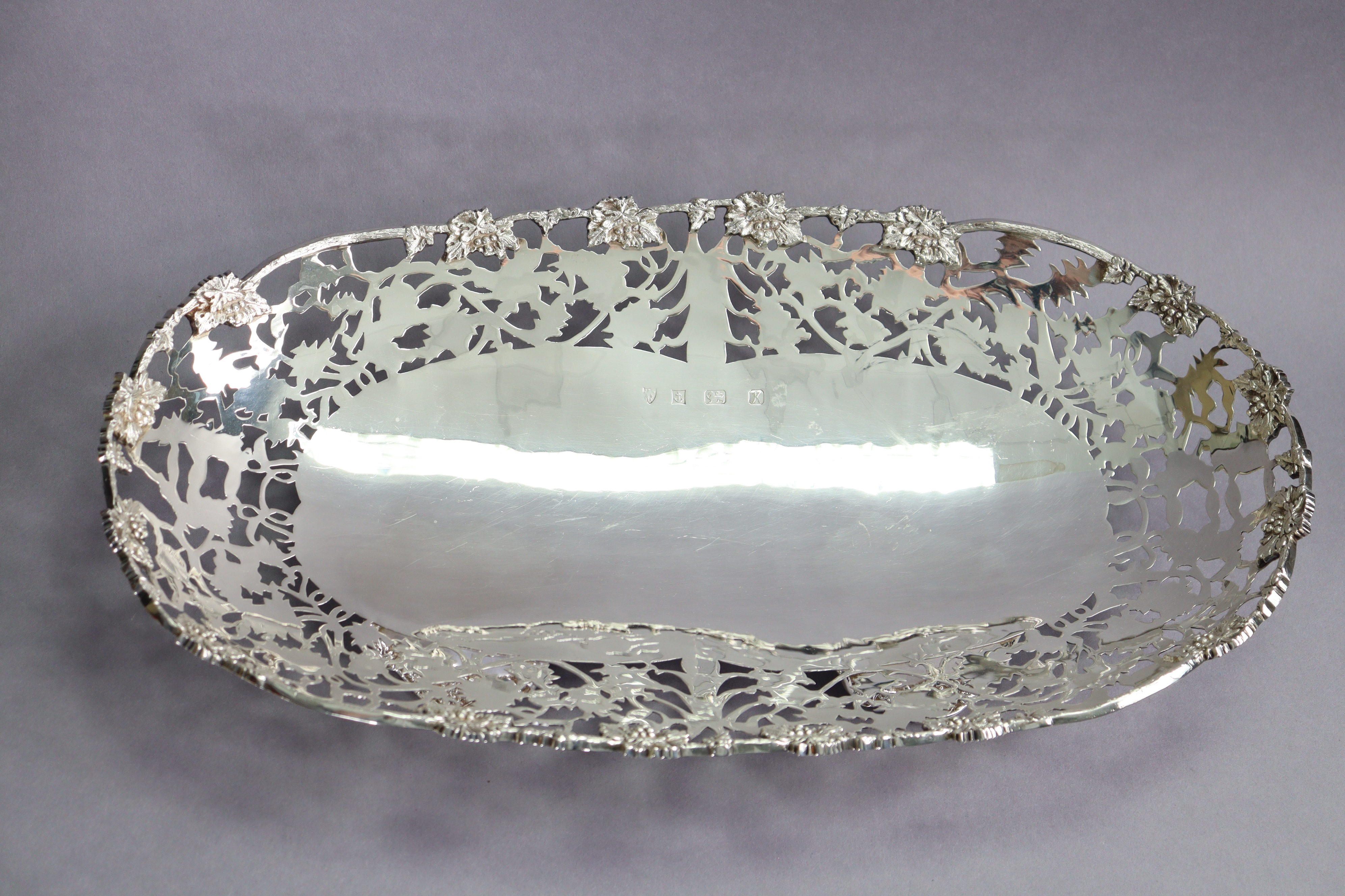 An Elizabeth II silver large oval dish with cast grapevine rim & wide pierced border, on four - Image 3 of 4