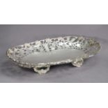 An Elizabeth II silver large oval dish with cast grapevine rim & wide pierced border, on four