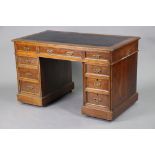 A late Victorian oak pedestal desk with moulded edge to the rectangular top, inset black leather
