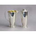 An Elizabeth II silver cream jug & matching sugar sifter of slender round tapered form, with angular