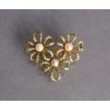 A 14K brooch designed as three open-work flowers, each centred by a cultured pearl, 1½” wide. (6.