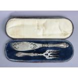 A pair of Victorian silver fish servers with pierced & engraved blades & loaded fancy handles;