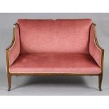 An Edwardian inlaid-mahogany framed two-seater sofa with square back & down-swept arms,