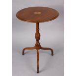 A Georgian mahogany tripod table with central inlaid roundel to the fixed circular top, on vase-