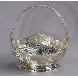 A George VI silver large basket dish with over-hang handle, all-over pierced decoration & raised