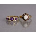 A 9ct gold ring set three amethysts with pairs of small white stones in between, size H/I, 2.2g; &