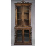 A late 19th century Flemish-style carved oak cabinet, fitted two adjustable shelves to the upper & l