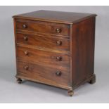 An early 19th century mahogany chest commode with moulded edge to the hinged lift-top,