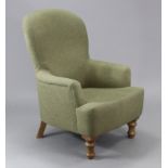 An Odeon spoon-back armchair upholstered pale green material, & on turned legs.