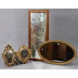 A gilt frame oval wall mirror with a beaded edge & inset with a bevelled plate, 21” x 34½”; together