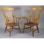 A pair of lath-back elbow chairs with hard seats, & on turned legs with spindle stretchers.