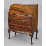 A mahogany bureau with a fitted interior enclosed by a fall-front above three long drawers, & on