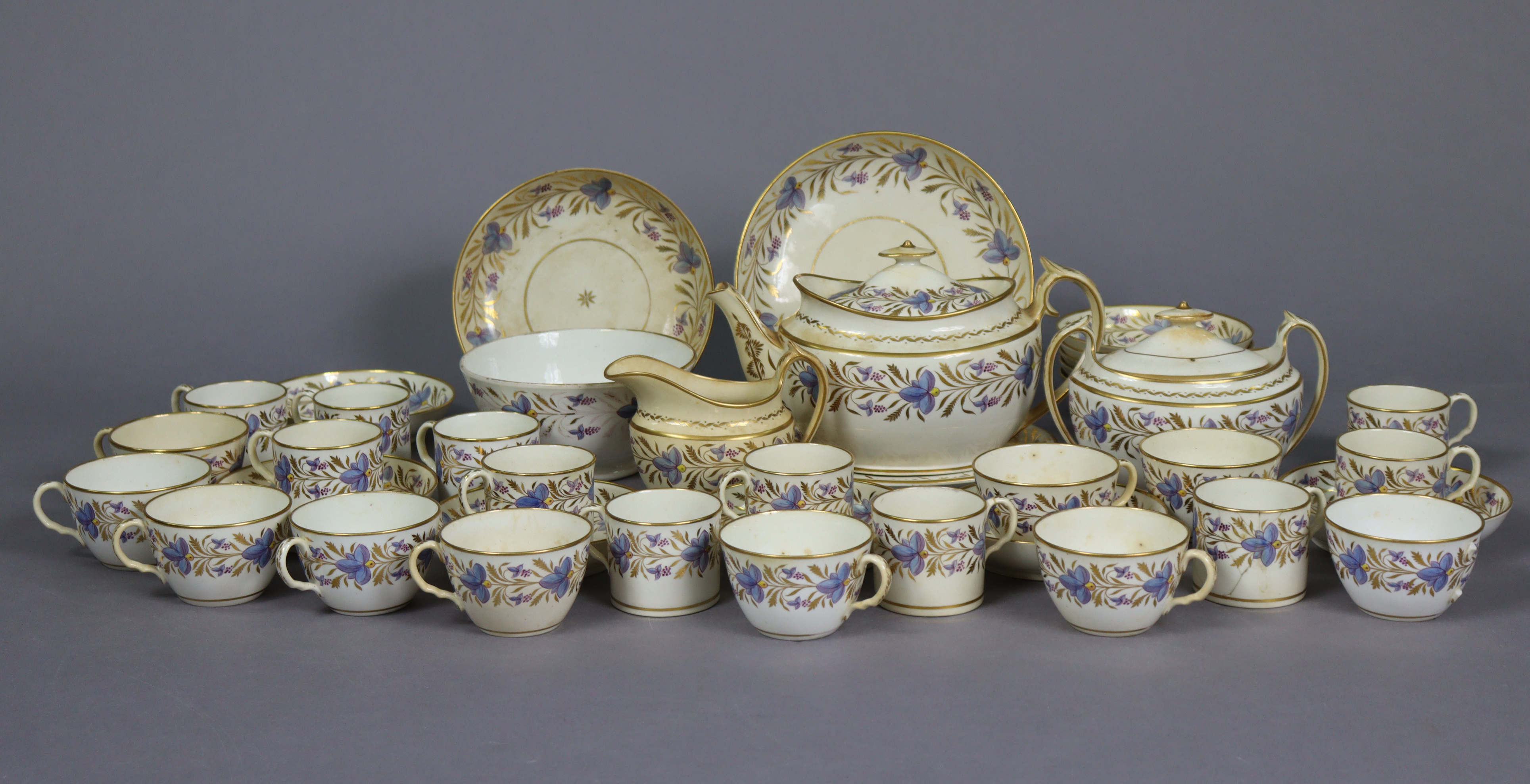 An early 19th century English porcelain thirty-nine piece part tea-coffee service with floral & gilt