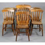 An elm spindle-back elbow chair with a hard seat; & on turned legs with spindle stretchers; & six