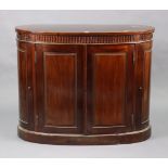 A 19th century-style mahogany bow-front dwarf cabinet with a moulded frieze, fitted shelf enclosed