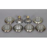 A pair of sterling silver dwarf candlesticks, 2¼” high; & a set of six sterling silver coasters each