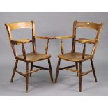 A pair of elm rail-back elbow chairs with hard seats, & on turned legs with spindle stretchers.
