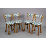 A set of four oak dining chairs with padded seats & backs upholstered floral material, & on turned