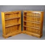 A pine four-tier standing open bookcase on a shaped plinth base; & a ditto three-tier standing