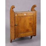 An oak wall cupboard fitted centre shelf enclosed by a panel door, & with shaped end supports, 20 ¾”