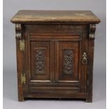 An antique oak dwarf cupboard enclosed by a carved panel door, 29¾” wide x 30¾” high x 22¾” deep.