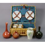 A wicker hamper with contents, & four various pottery vases.