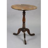 A 19th century mahogany tripod table with a circular top, & on a vase-turned centre column & three