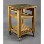 A beech square three-tier kitchen island on square supports with castors, 24” wide x 34¼” high.