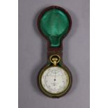 A late 19th/early 20th century pocket aneroid barometer in gilt-brass case, the 1¾” silvered dial in