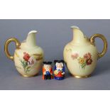 Two Royal Worcester porcelain ewers of blush ivory ground, with bright-coloured floral decoration,