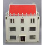 A painted wooden three-storey doll’s house with an opening front, 30¾” wide x 38” high x19” deep.