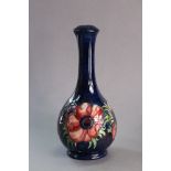 A Moorcroft pottery “Poppy” pattern table lamp base of void shape with tall slender neck, on a