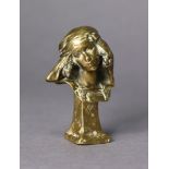 A gilt bronze wax seal in the form of a female bust wearing headscarf a & looking to her right,