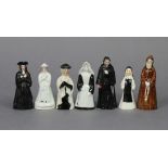 A Staffordshire pottery candle snuffer in the form of a parson; two porcelain ditto of a nun & a