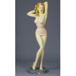 AN ART DECO STYLE LARGE COMPOSITION MODEL OF A PIN-UP GIRL, standing on painted fibreglass base,