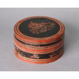 A Burmese black & red lacquer work cylindrical box with figure scene decoration to the lid, 6¼”