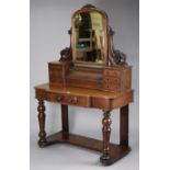 A Victorian mahogany break-front duchess dressing table with a rectangular swing mirror to the stage