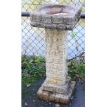 A reconstituted stone bird bath, 14” wide x 33” high.