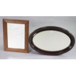 A 1930s mahogany frame oval wall mirror with a beaded edge, & inset bevelled plate, 21” x 31”; & a