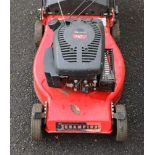 A champion petrol-driven lawnmower, with grass box.