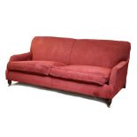 An Andrew Martin three-seater settee with a rounded back & with loose cushions to the seat
