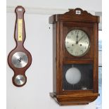 A mid-20th century wall clock with a striking movement, and in an oak case, 25” high, together