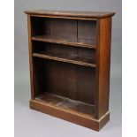 An early 20th century mahogany standing open bookcase with three adjustable shelves, & on a plinth