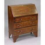 An Edwardian inlaid mahogany small bureau with a fitted interior enclosed by a fall-front above