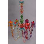 A vintage Murano glass chandelier with six scroll arms hung with prism drops, 24” high x 20” wide.
