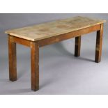 An oak work bench with a narrow rectangular top, and on square legs, 68” long x 30” high x 23¼”