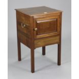 An early 20th century inlaid-mahogany bedside cupboard enclosed by a panel door, & on square legs,