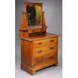 An Edwardian oak dressing chest with a rectangular swing mirror to the stage-back, fitted three long