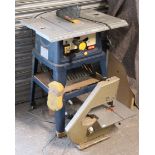 A Ryobi 240V circular saw on a table base, 28½” wide x 36” high; & a Burgess 230V bandsaw.