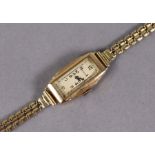 A Benson 9ct. gold Art Deco ladies’ wristwatch, the rectangular white dial with black Arabic